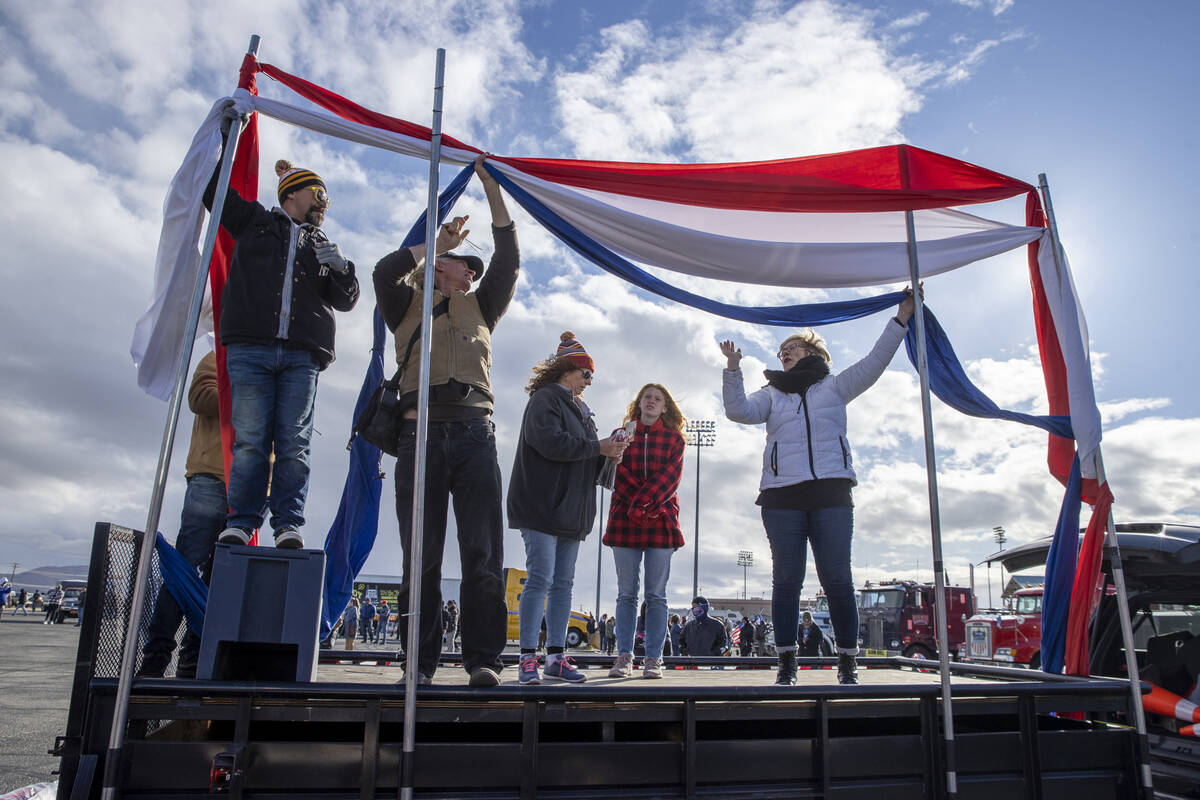 Organizers set up a stage for speakers for The People’s Convoy send off event at Adelant ...
