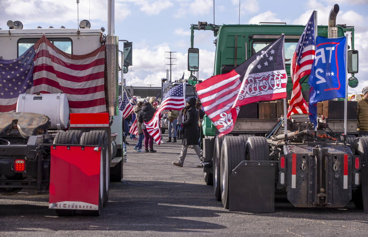 Flags and signs are plentiful during a departure event for The People’s Convoy at Adelan ...