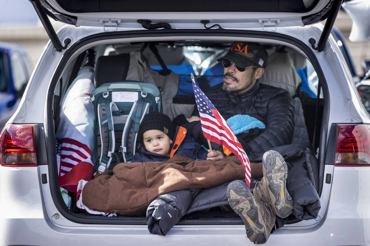 Attendee Jodi Mateo of California holds James, 1, and Kaleo Mateo, 2, as he sings Amazing Grace ...