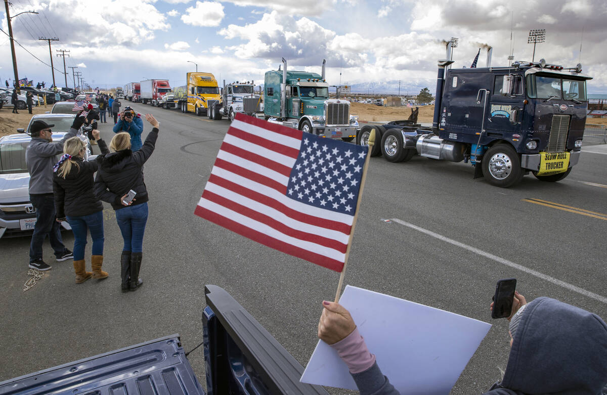 Supporters wave flags and cheer for truckers departing from a send-off event for The People’s ...