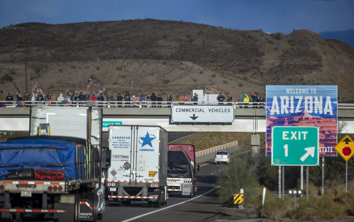 Supporters line an I-40 overpass at the Arizona border awaiting The People’s Convoy who ...