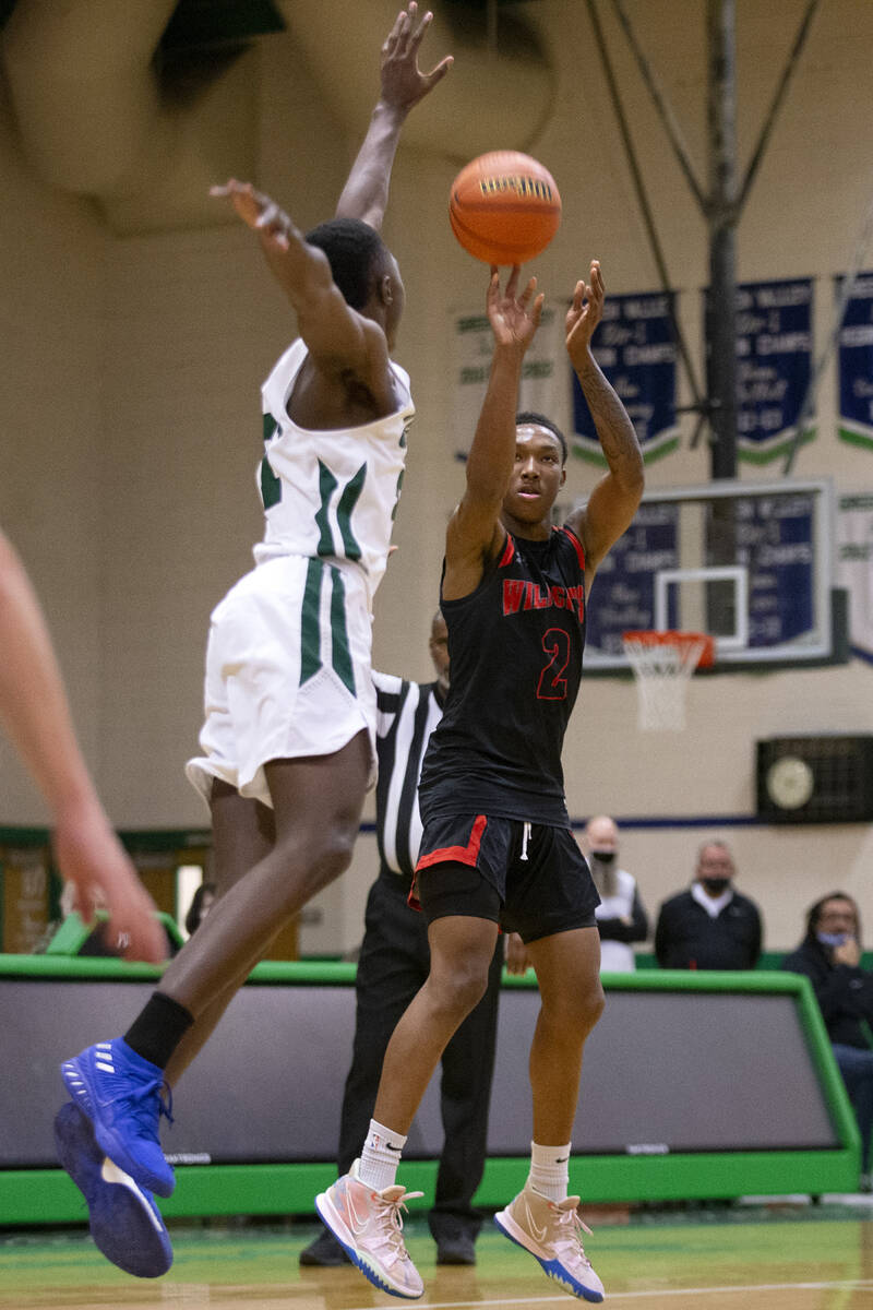 Las Vegas’ Tavionte Jackson (2) shoots a three-pointer against Green Valley’s Kaylan Doby d ...