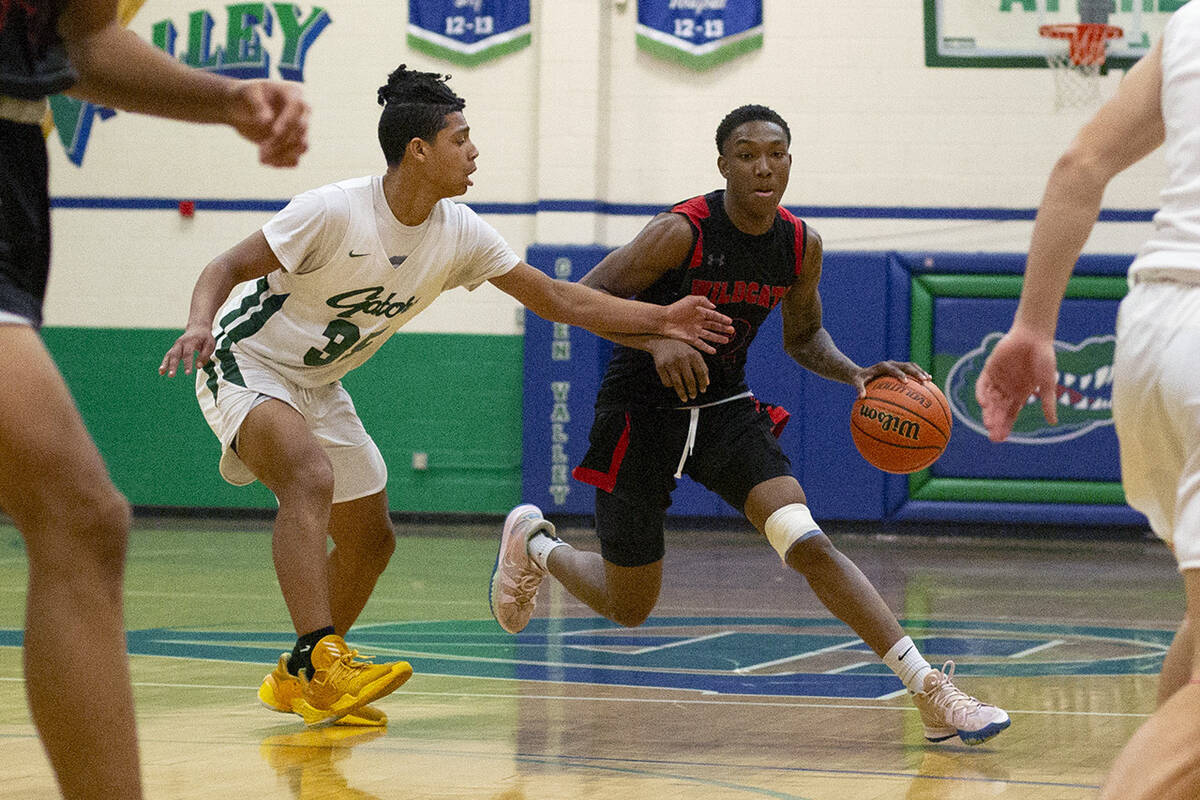 Las Vegas’ Tavionte Jackson drives around Green Valley’s Gaston Zumaye during a boys high s ...