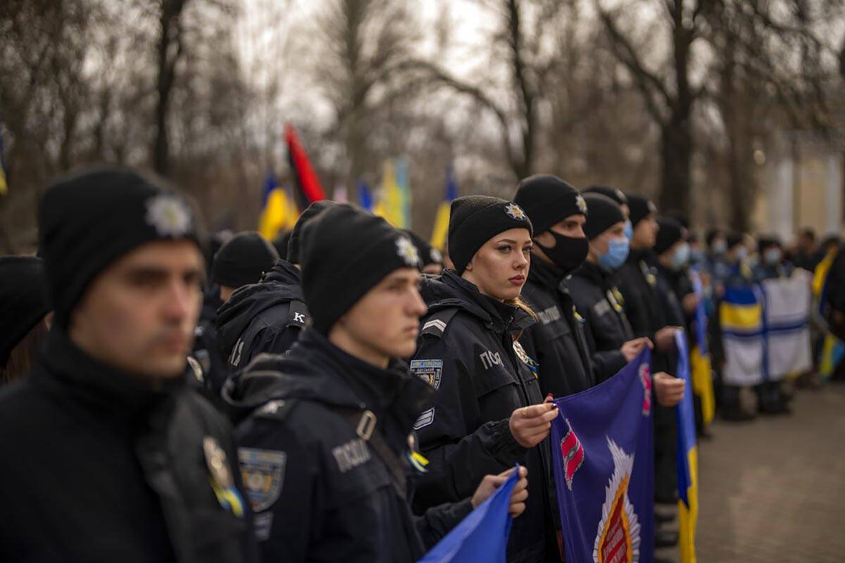 Police officers take part in a protest in Odessa, Ukraine, Sunday, Feb. 20, 2022. Thousands of ...