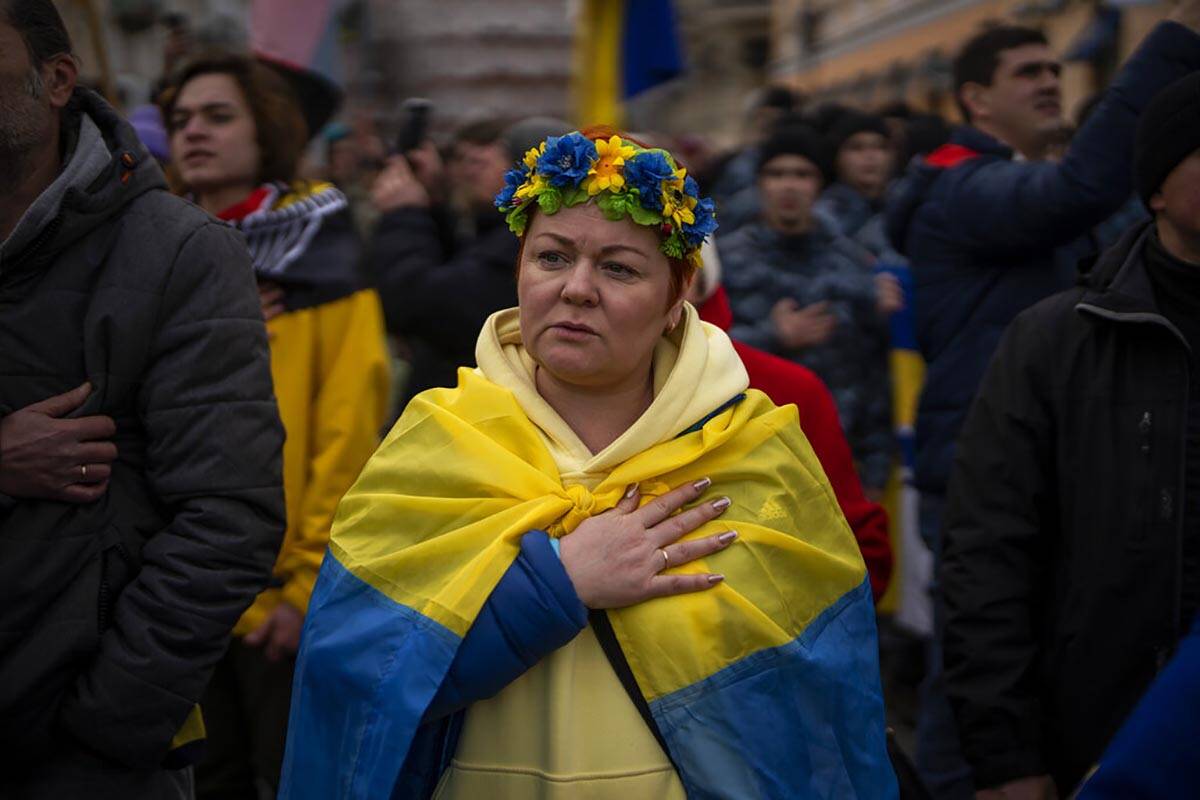 Demonstrators sing the national anthem during a protest in Odessa, Ukraine, Sunday, Feb. 20, 20 ...