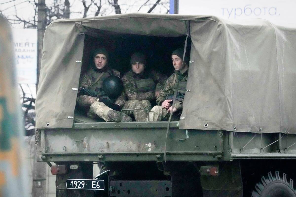 Ukrainian soldiers ride in a military vehicle in Mariupol, Ukraine, Thursday, Feb. 24, 2022. (A ...