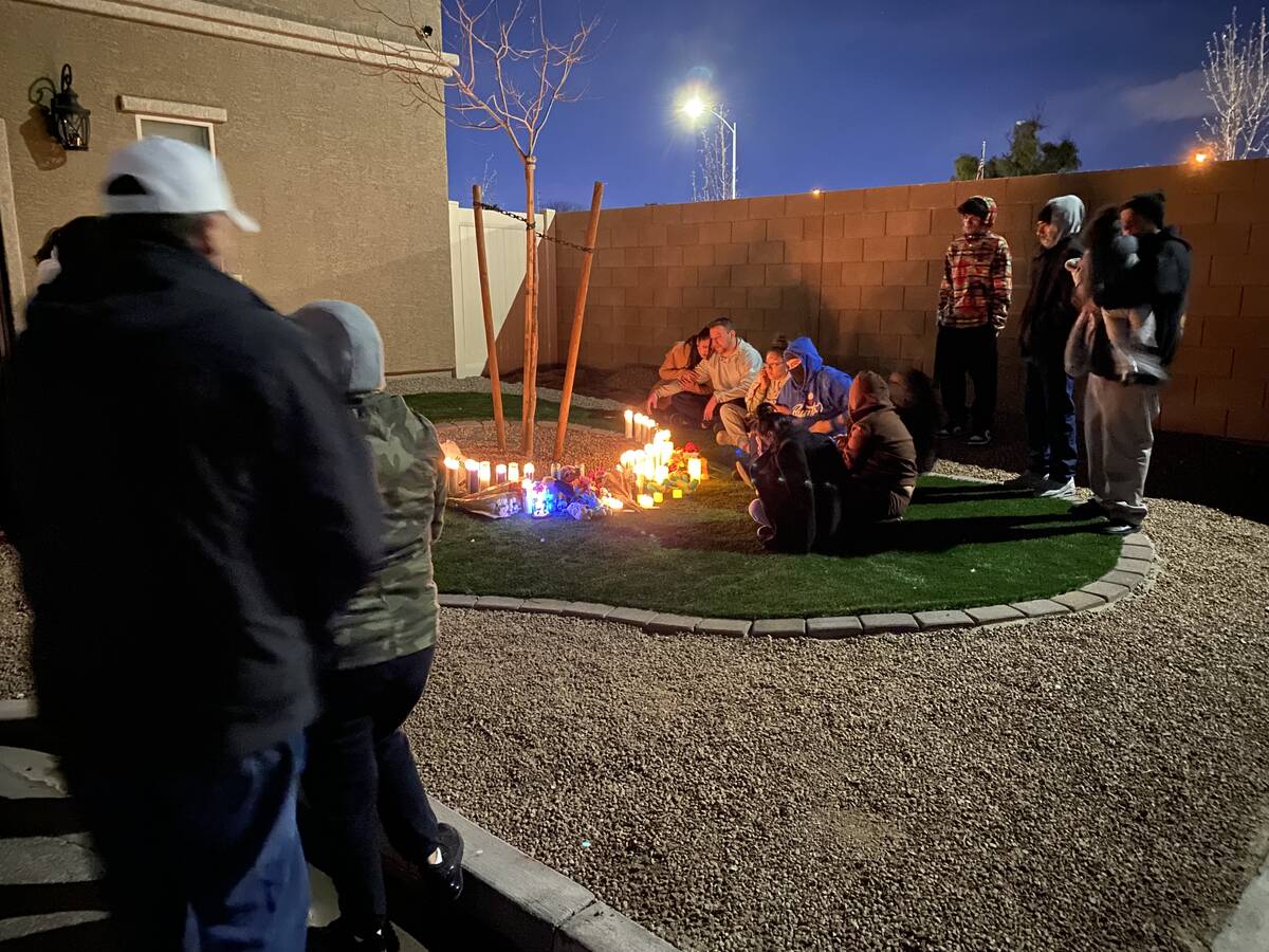 People gather around a memorial for Mason Dominguez, 4, at 4307 Saddle Brook Park Drive on Wedn ...