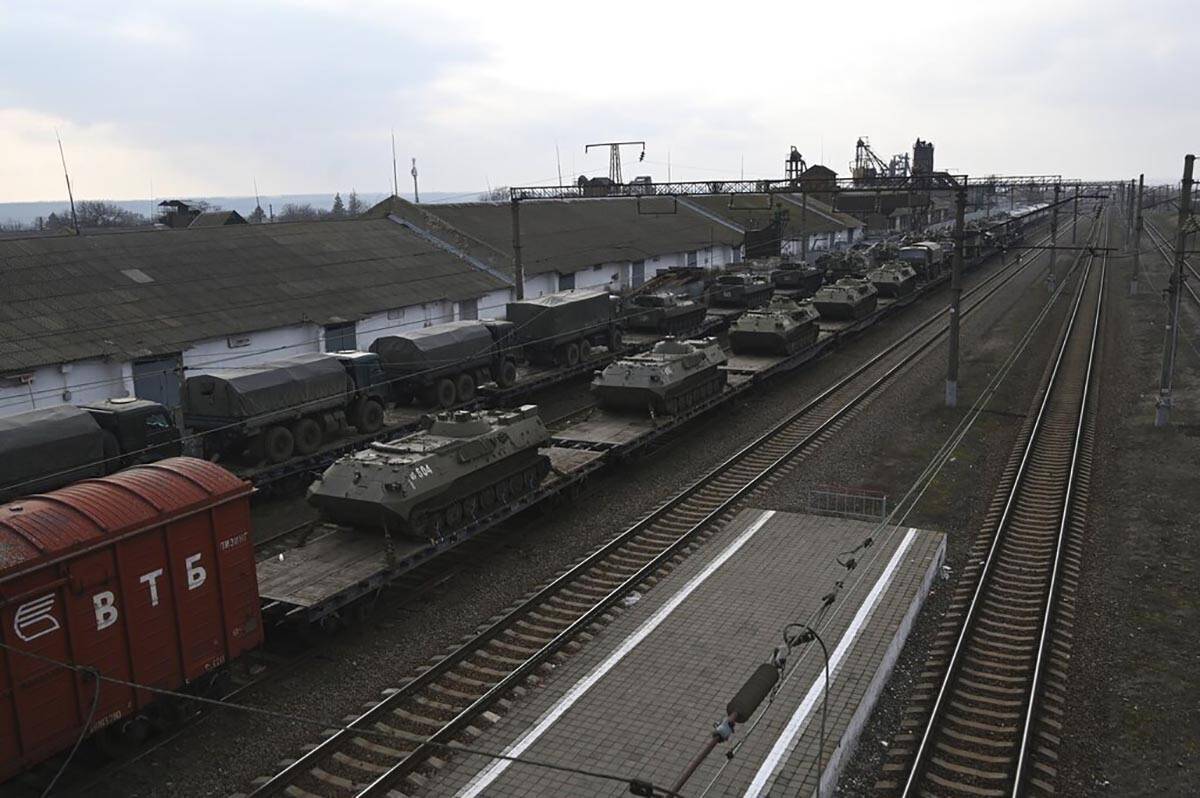 Russian armored vehicles are loaded onto railway platforms at a railway station in region not f ...
