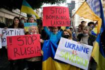 Ukrainians who live in Lebanon holds placards and chant slogans during a protest against Moscow ...