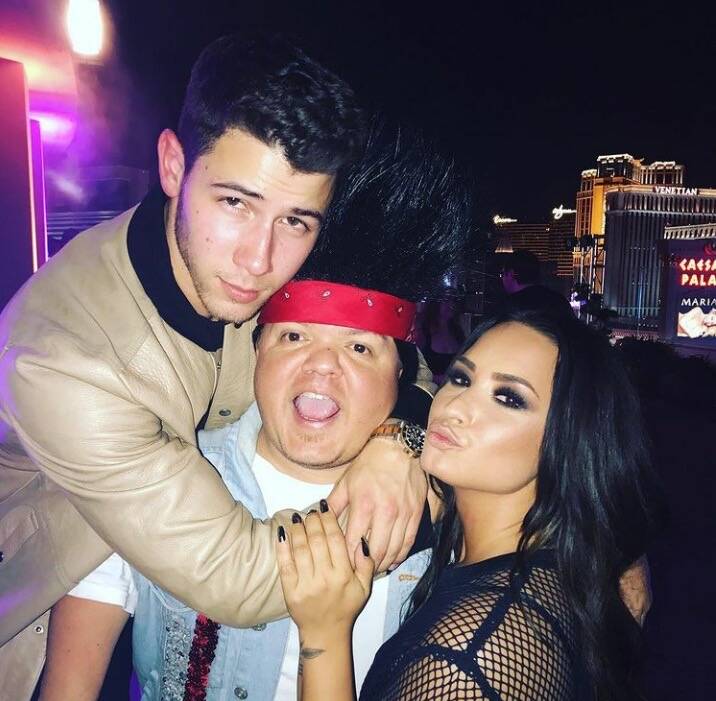 Donny Davis is shown with Nick Jonas and Demi Lovato in this undated photo. Davis died Tuesday ...