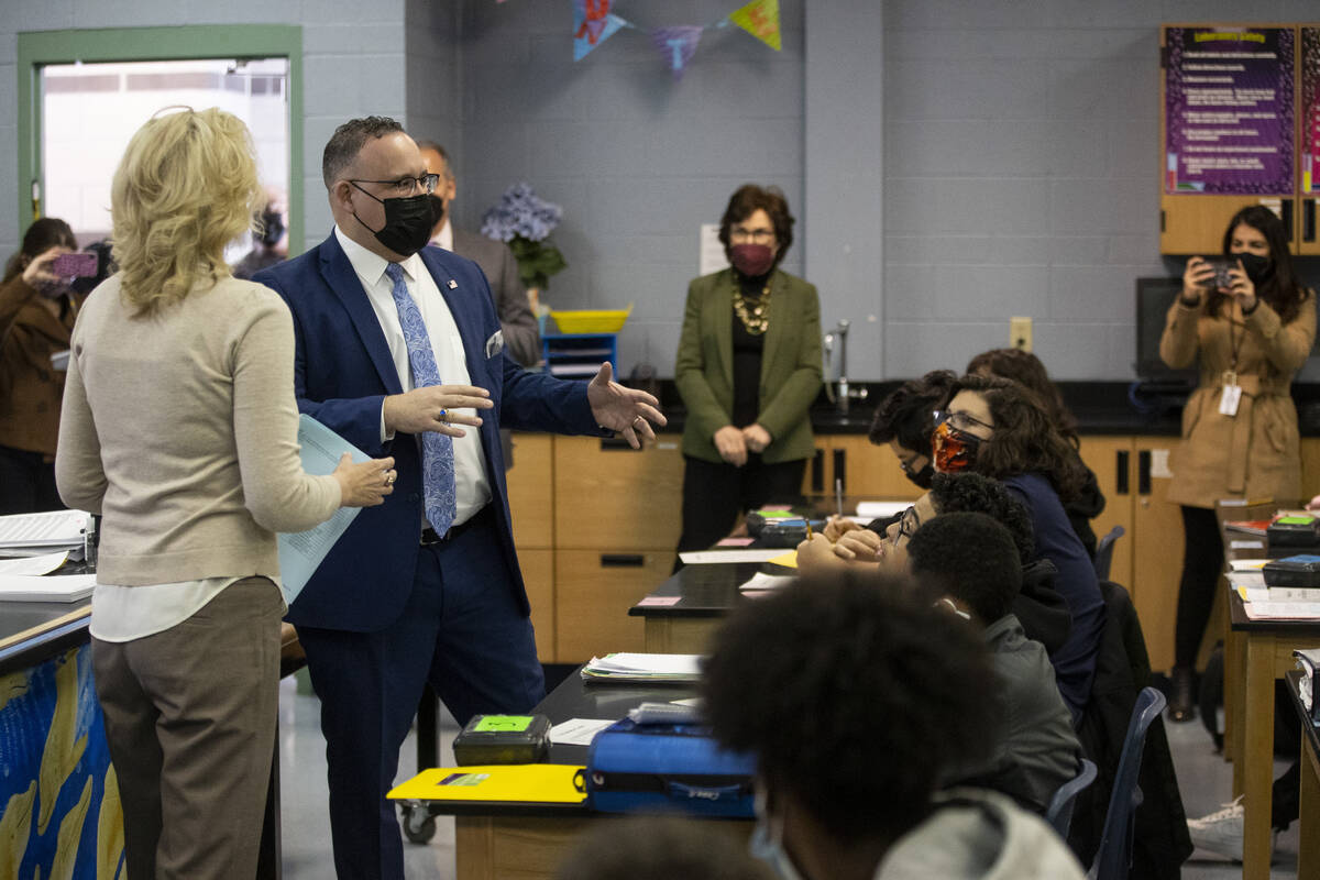 U.S. Secretary of Education Miguel Cardona, center, speaks to biology class students during a t ...