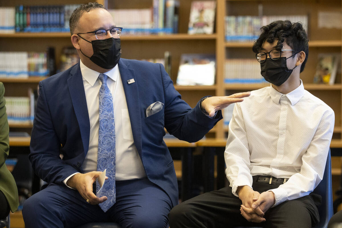 U.S. Secretary of Education Miguel Cardona, left, with student Miguel Torres, participates duri ...