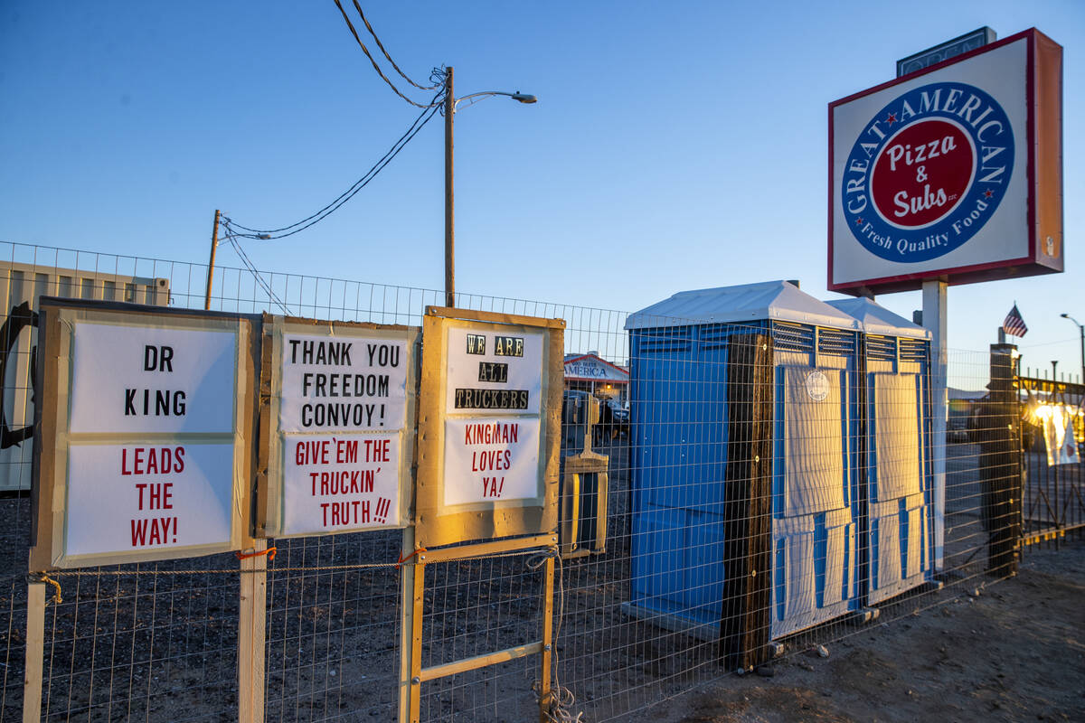 Signs in support of truckers and The People’s Convoy parked for the night at the Great A ...