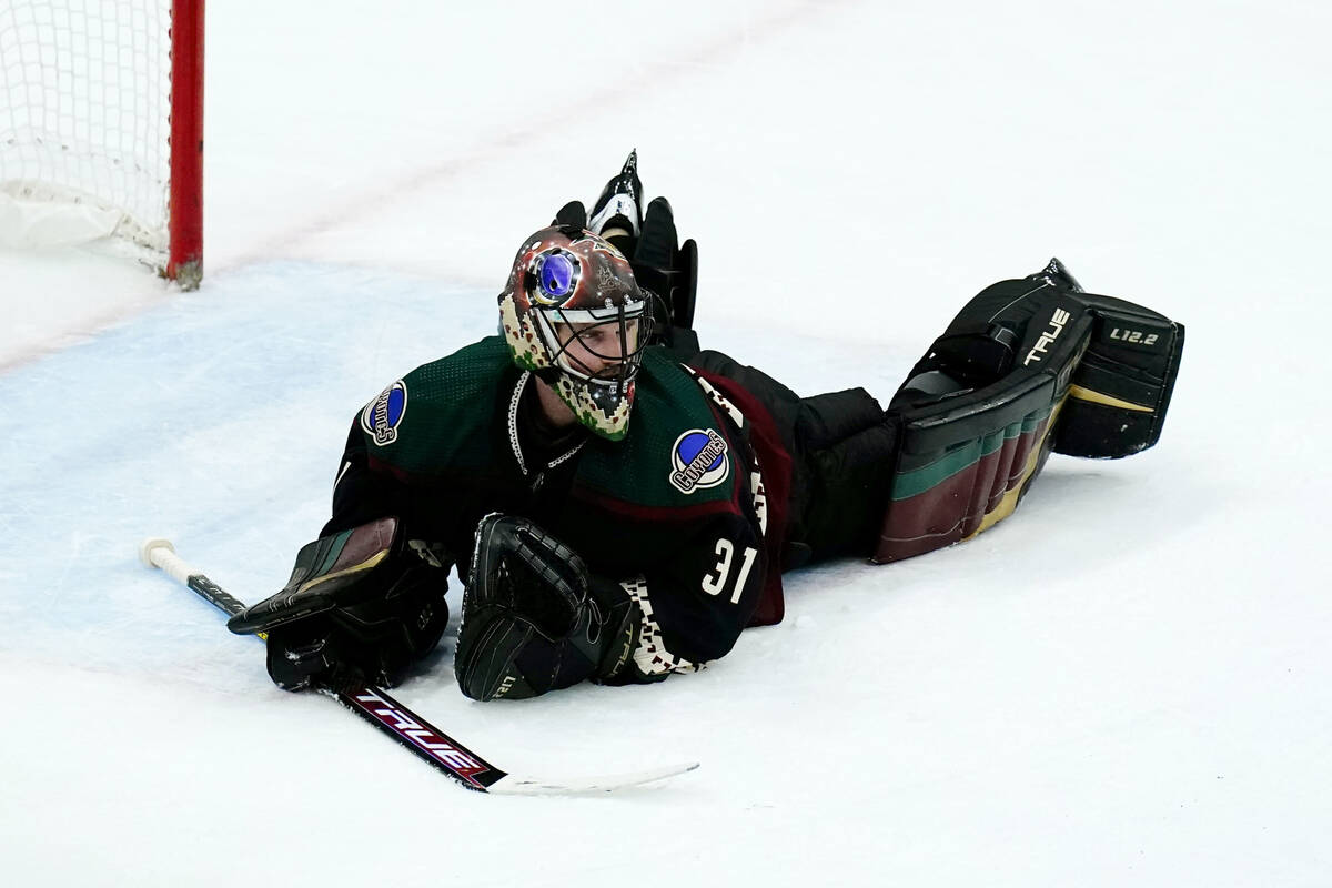 Arizona Coyotes goaltender Scott Wedgewood pauses on the ice after making several saves against ...