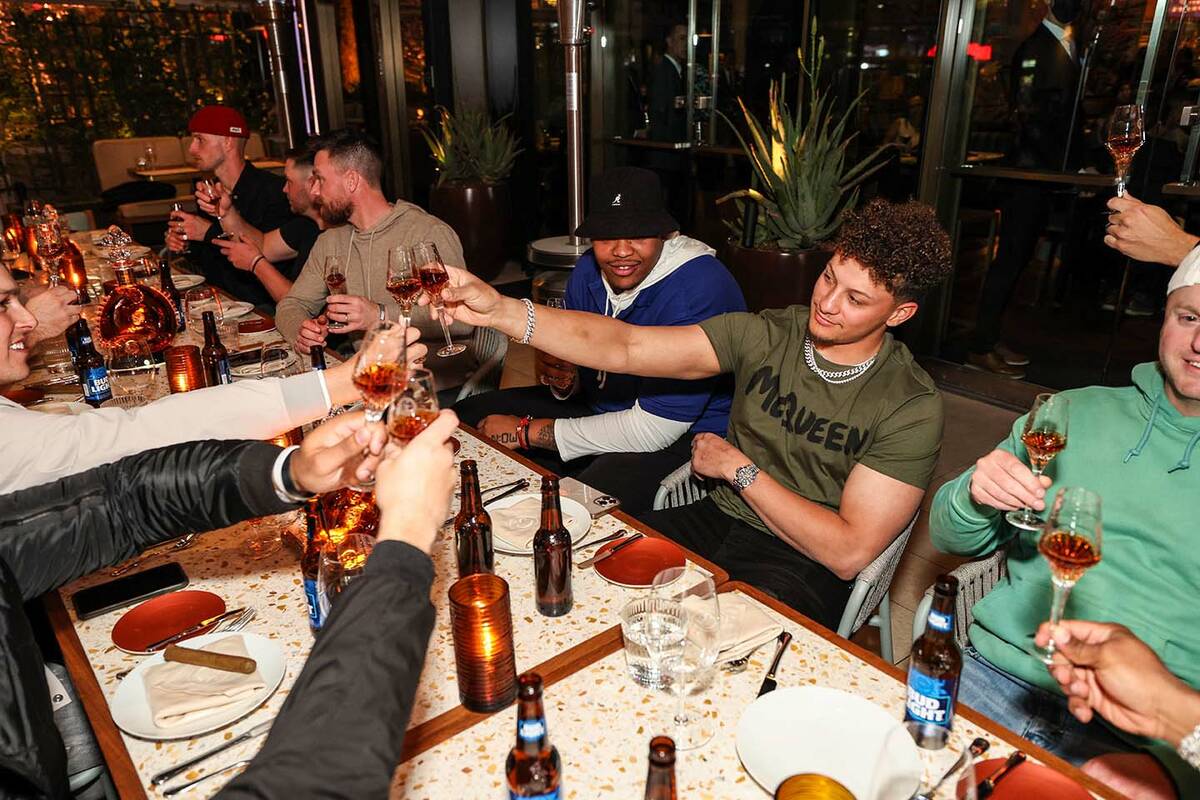 Kansas City Chiefs star quarterback, Patrick Mahomes, raises his glass during a dinner for his ...