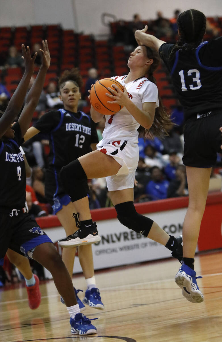 Las Vegas High School's Layla Faught (1) goest to the basket as Desert Pines High School's Tave ...