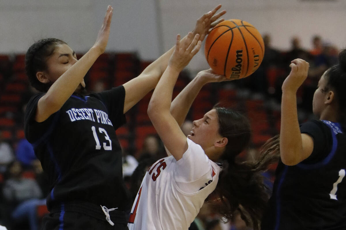 Las Vegas High School's Layla Faught (1) goest to the basket as Desert Pines High School's Des ...