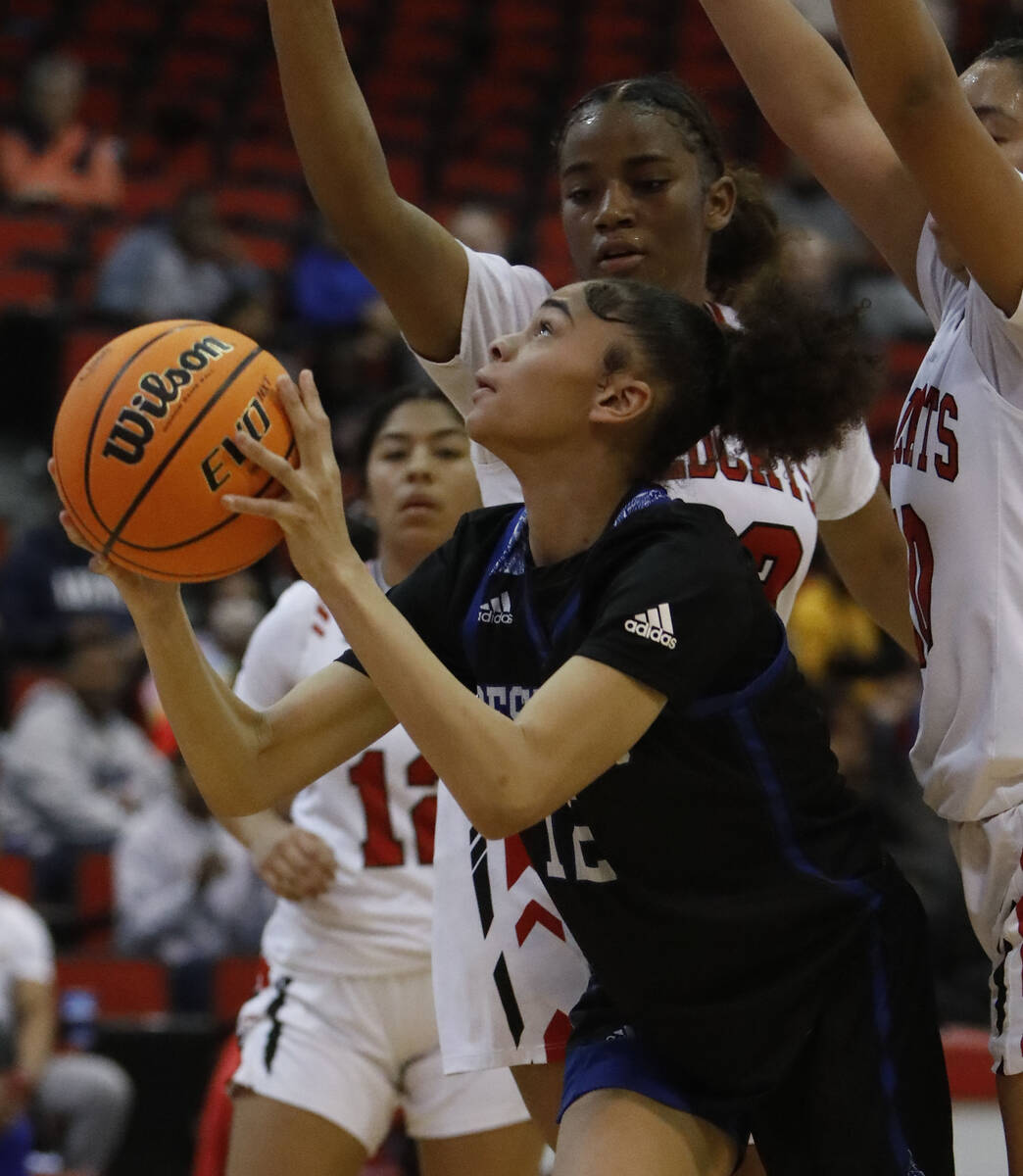 Desert Pines High School's Dayana Wilder (12), center, tries to shoot against Las Vegas High Sc ...