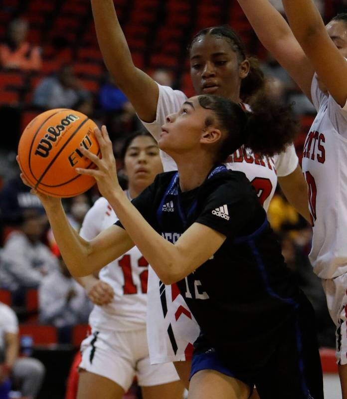 Desert Pines High School's Dayana Wilder (12), center, tries to shoot against Las Vegas High Sc ...