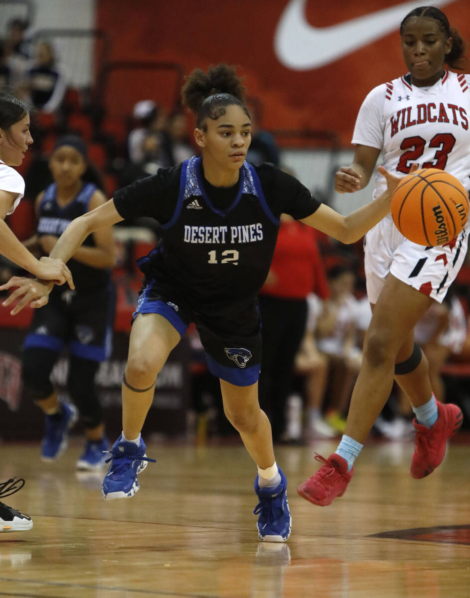 Desert Pines High School's Dayana Wilder (12) dribbles as Las Vegas High School's Kayla Terry ( ...