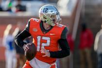 National Team quarterback Carson Strong of Nevada (12) rolls out to pass in an NCAA college foo ...