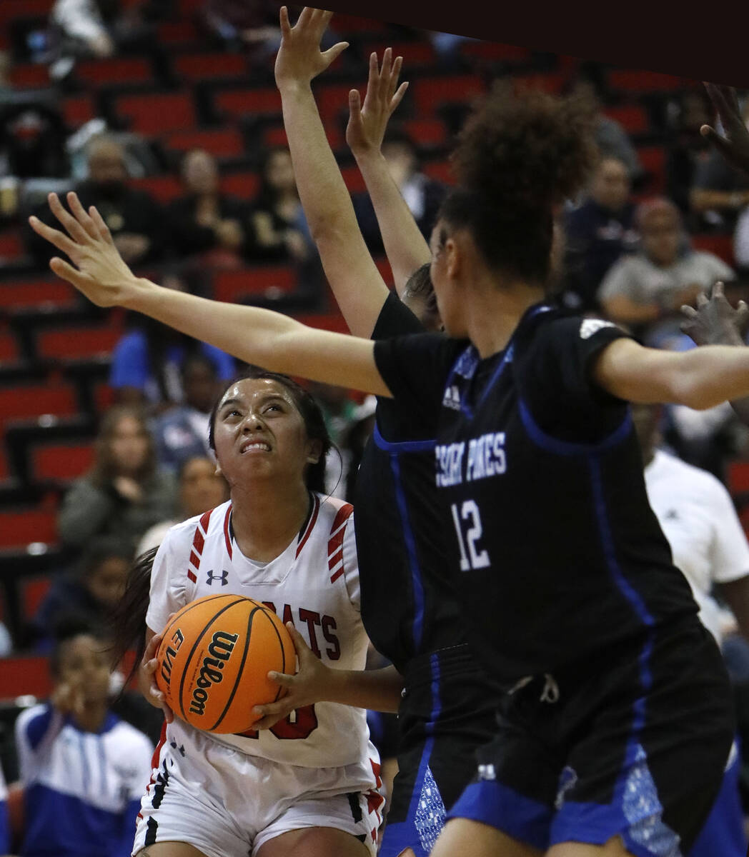 Las Vegas High School's Jennifer Portillo (12), left, looks to pass against Desert Pines High S ...