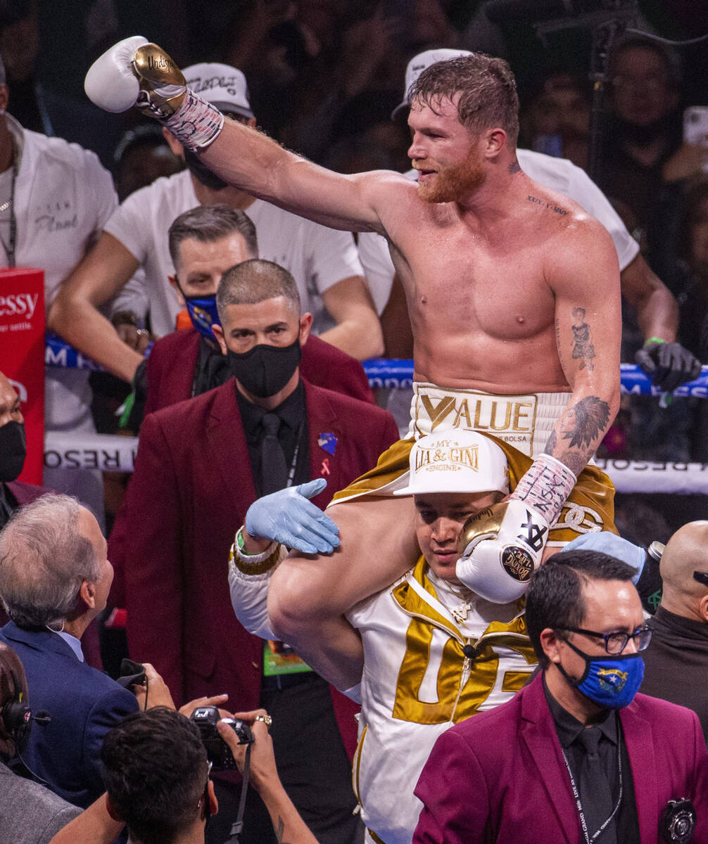 Saul "Canelo" Alvarez celebrates his win over Caleb Plant in the 11th round victory f ...