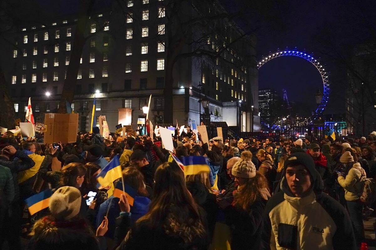 Demonstrators hold placards and Ukraine flags attend a protest outside Downing Street, with the ...