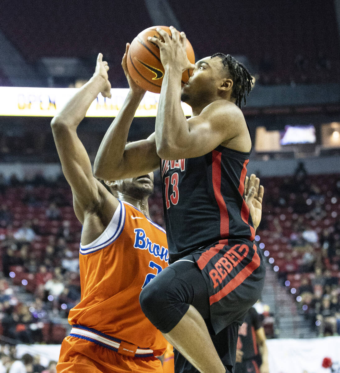 UNLV Rebels guard Bryce Hamilton (13) shoots over Boise State Broncos forward Abu Kigab (24) du ...