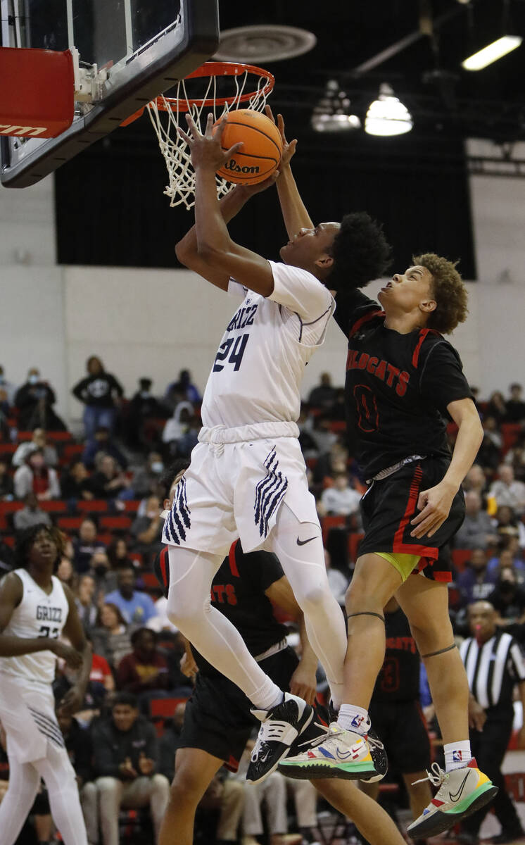 Spring Valley High School's Daysean Moreno (24) jumps to the basket as Las Vegas High School's ...