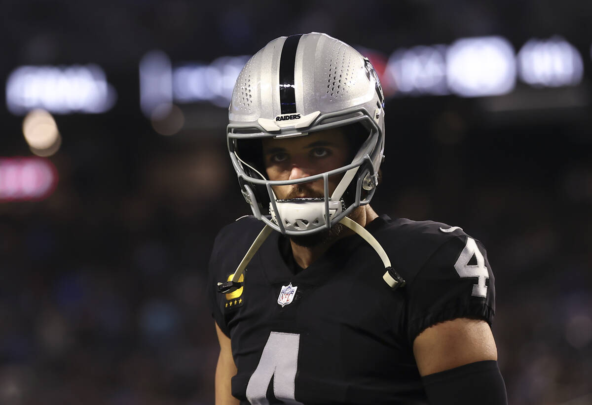 Raiders quarterback Derek Carr looks on before the start of an NFL football game against the Lo ...