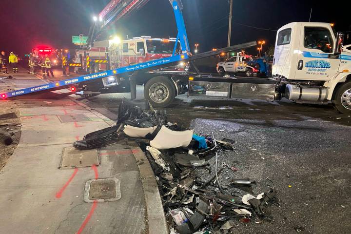 Authorities get set to tow a vehicle involved a six-car crash at the scene of a fatal crash on ...