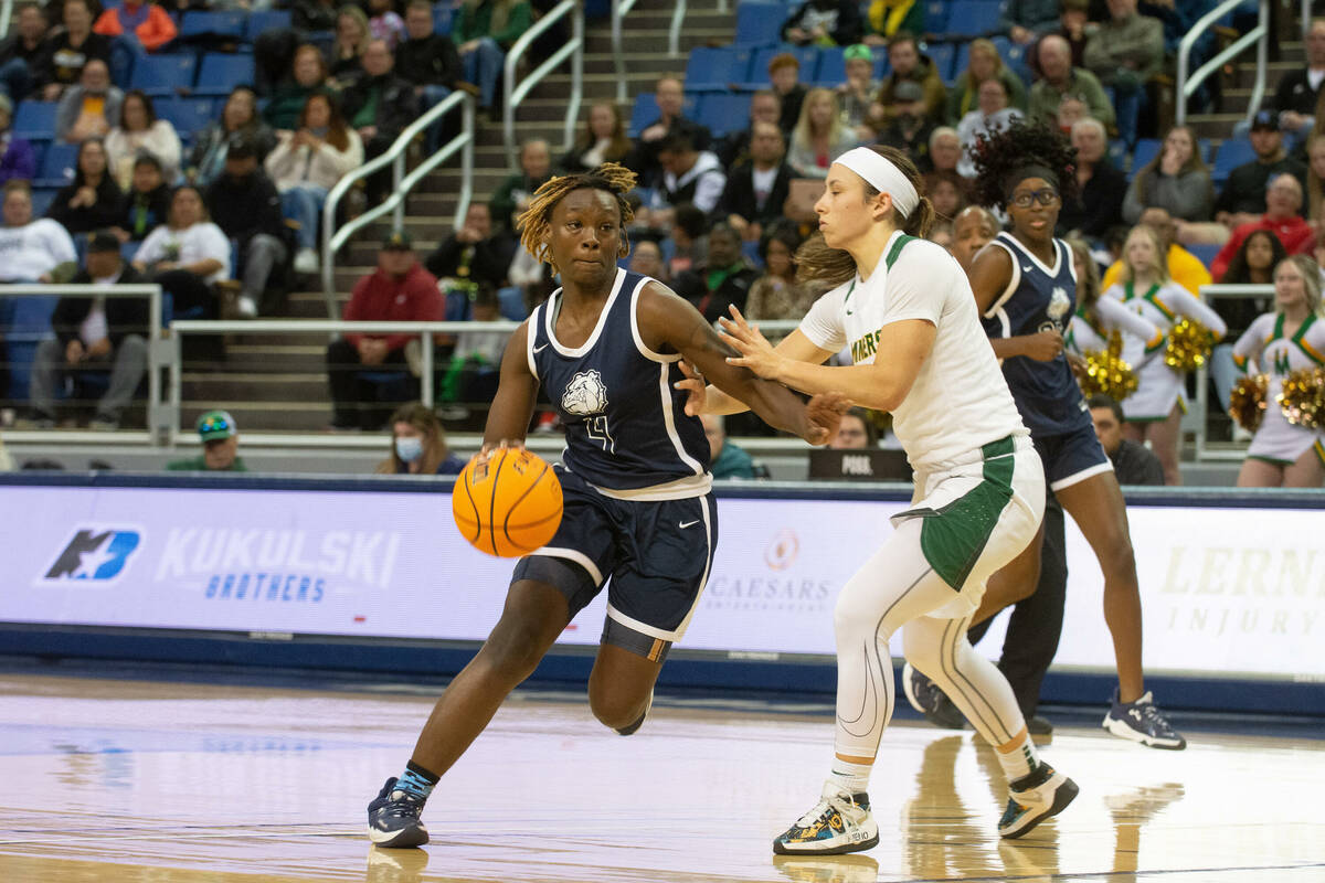 Mary Mcmorris of Centennial High School drives past Bishop Manogue defender Alyssa Premo during ...