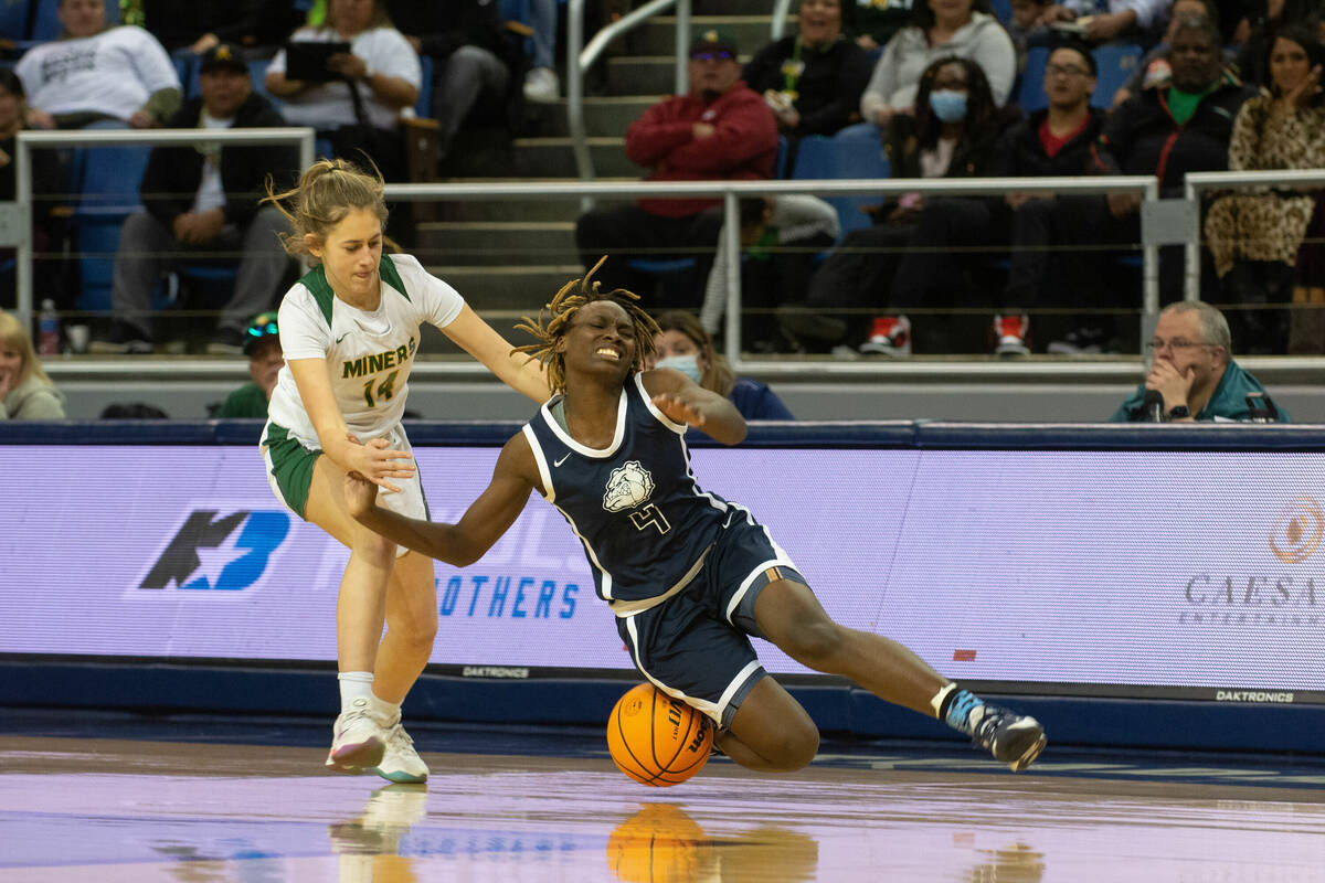 Mary Mcmorris of Centennial High School is fouled by Bishop Manogue's Anna Alonso during the NI ...