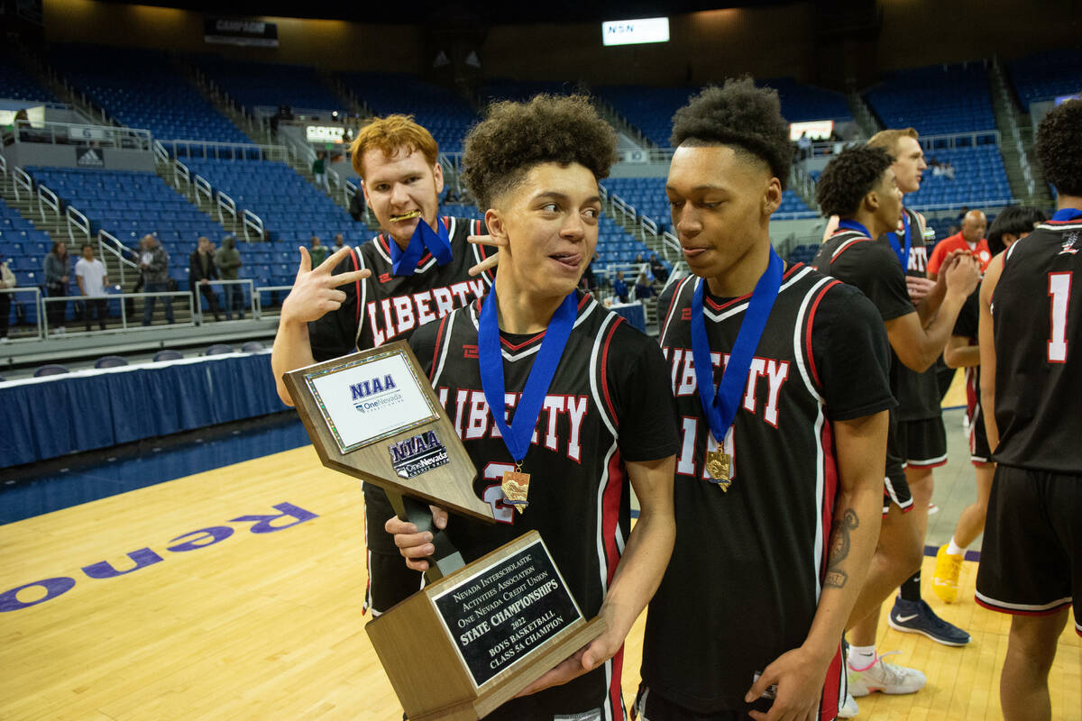 LibertyÕs Kristaps Kambala, center celebrates with his teammates after beating Bishop Gorm ...