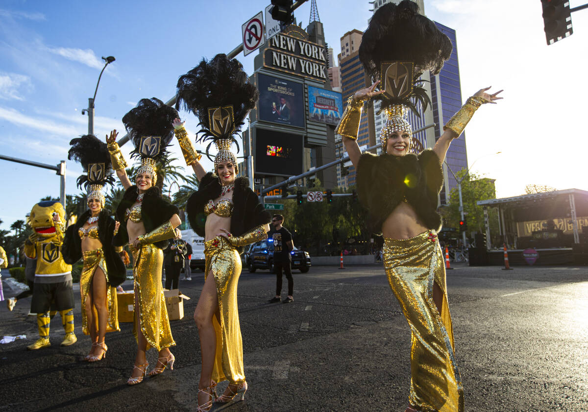 The Golden Belles cheer on runners with Golden Knights mascot Chance during the Rock ‘n& ...