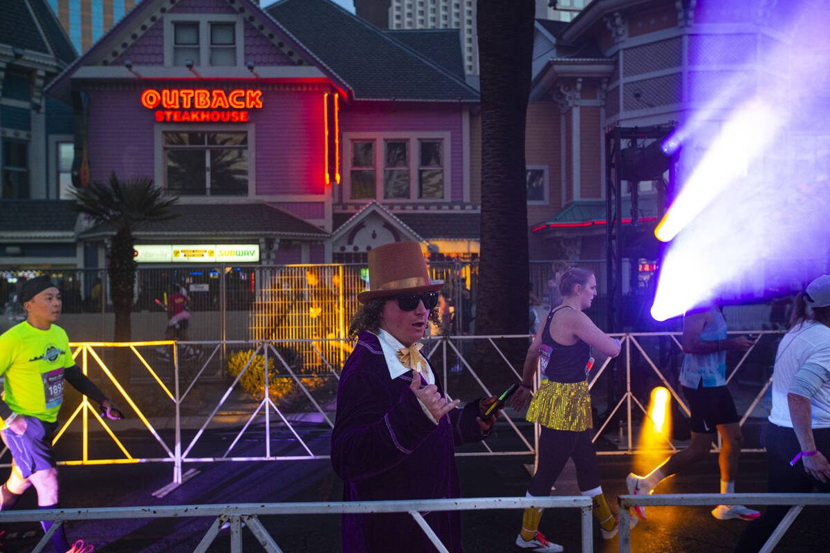 A participant dressed as Willy Wonka approaches the finish line during the Rock ‘n&#x201 ...