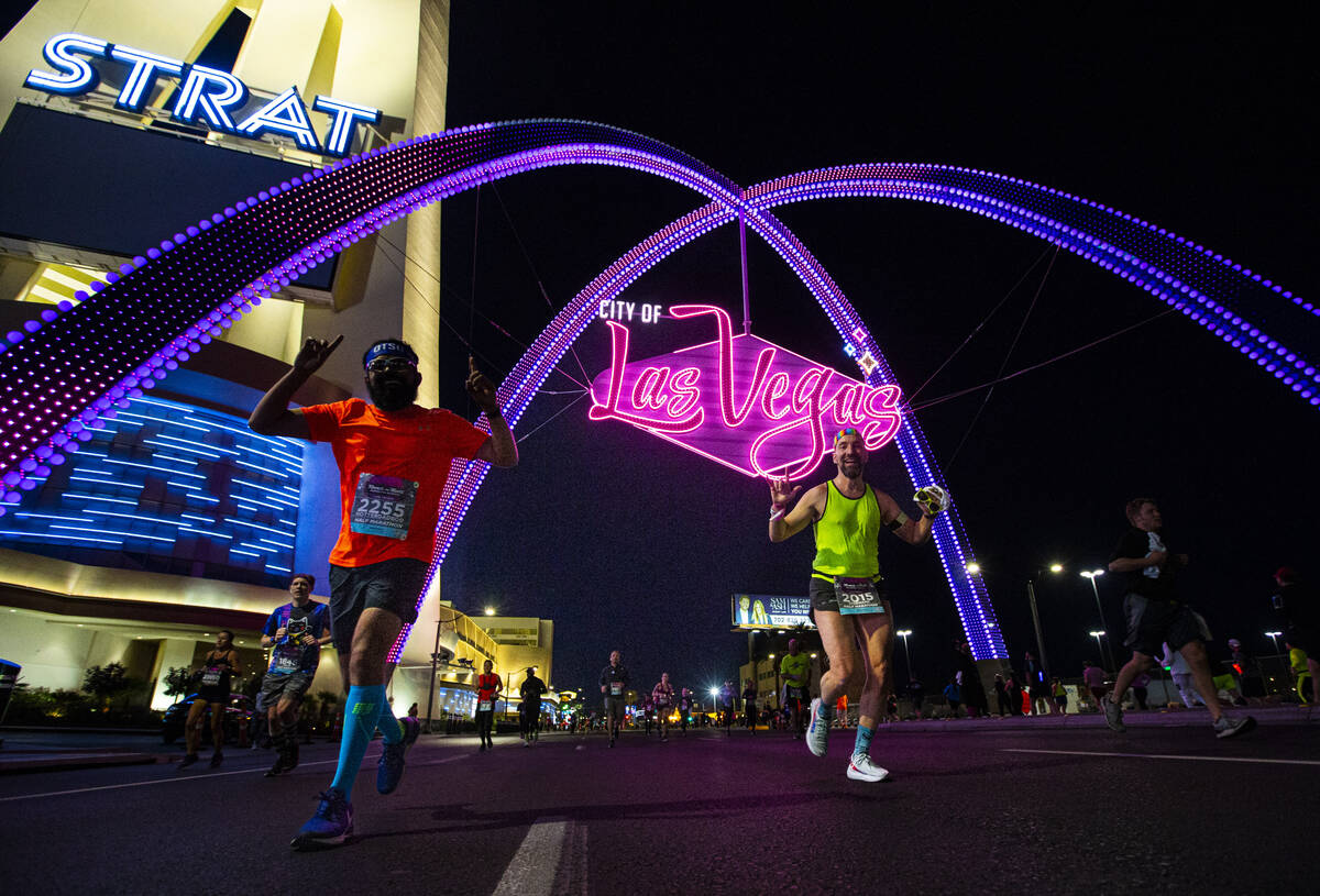 Participants run past the City of Las Vegas arch during the Rock ‘n’ Roll Las Veg ...