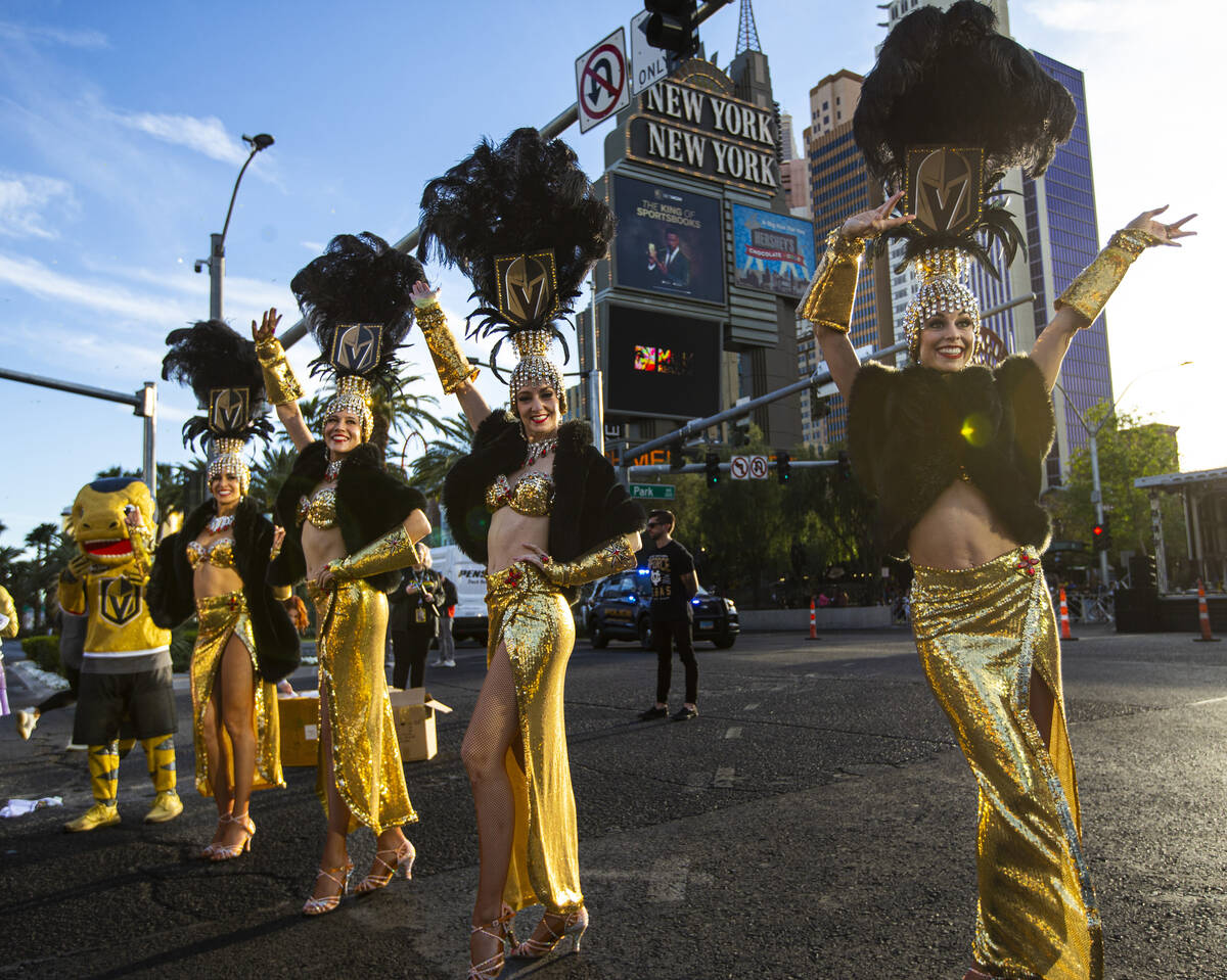 The Golden Belles cheer on runners with Golden Knights mascot Chance during the Rock ‘n& ...