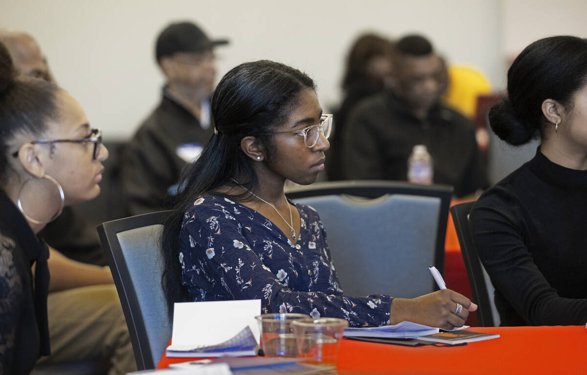 Jillian Perry, middle, listens to a speaker during a leadership summit for high school, uppercl ...