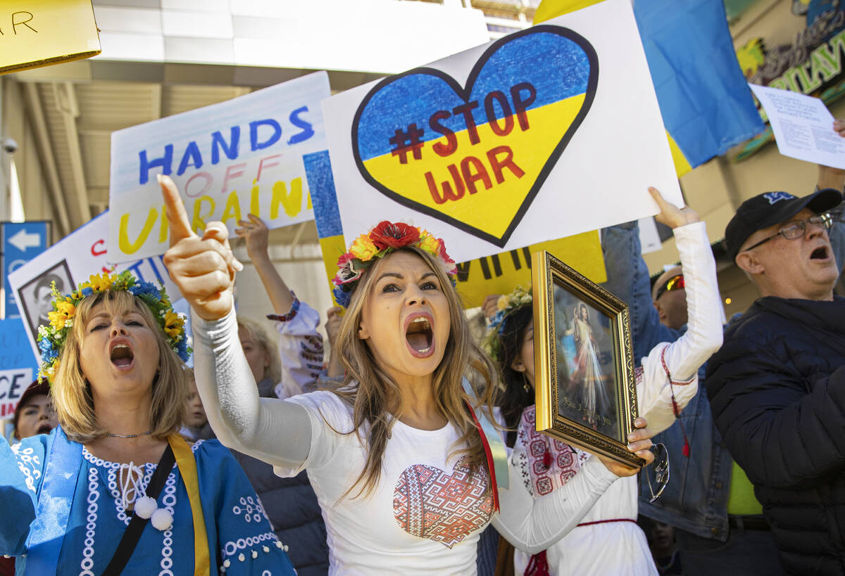 Jenny Arata, middle, from Kyiv, Ukraine, leads demonstrators during a protest over the Russian ...