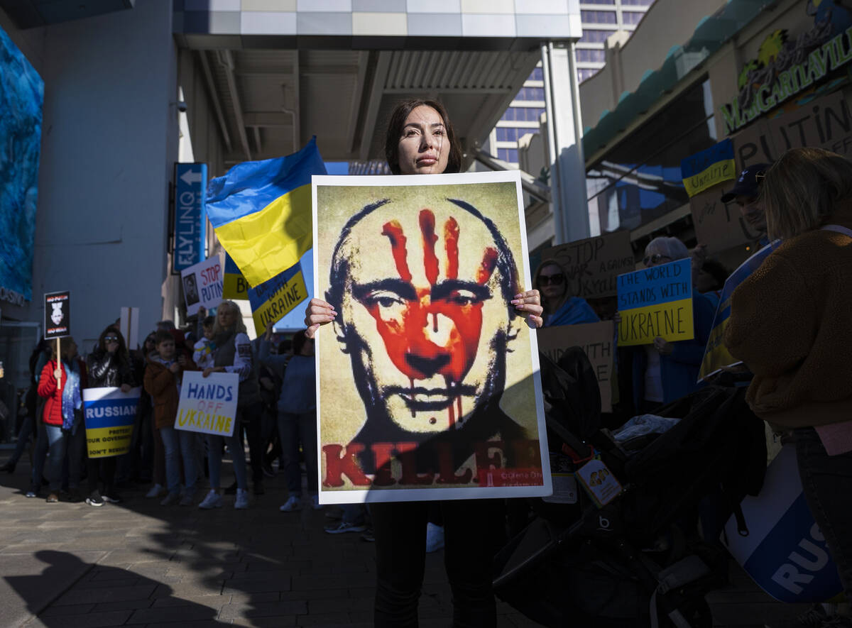 Demonstrators protest the Russian invasion of Ukraine on the Strip on Saturday, Feb. 26, 2022, ...