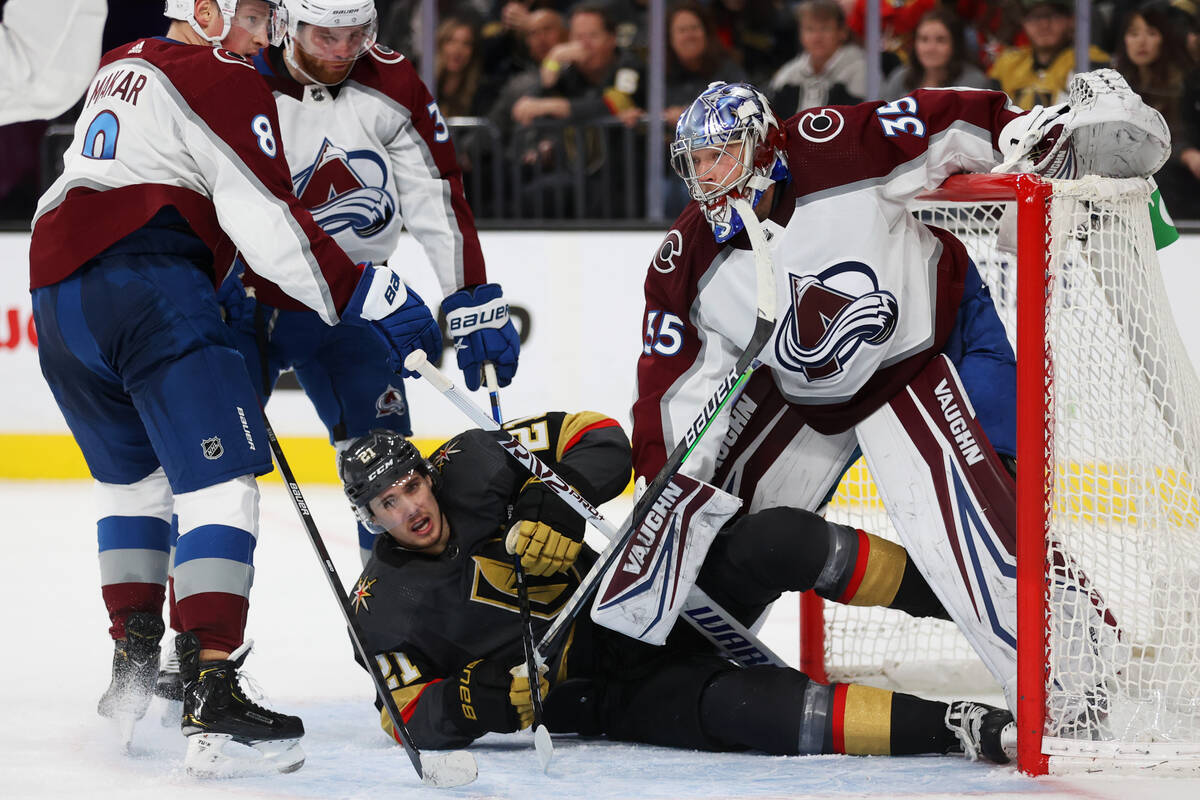 Vegas Golden Knights center Brett Howden (21) falls on the ice in front ofColorado Avalanche go ...