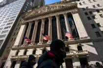 A pedestrian passes the New York Stock Exchange, Monday, Jan. 24, 2022, in New York. (AP Photo/ ...