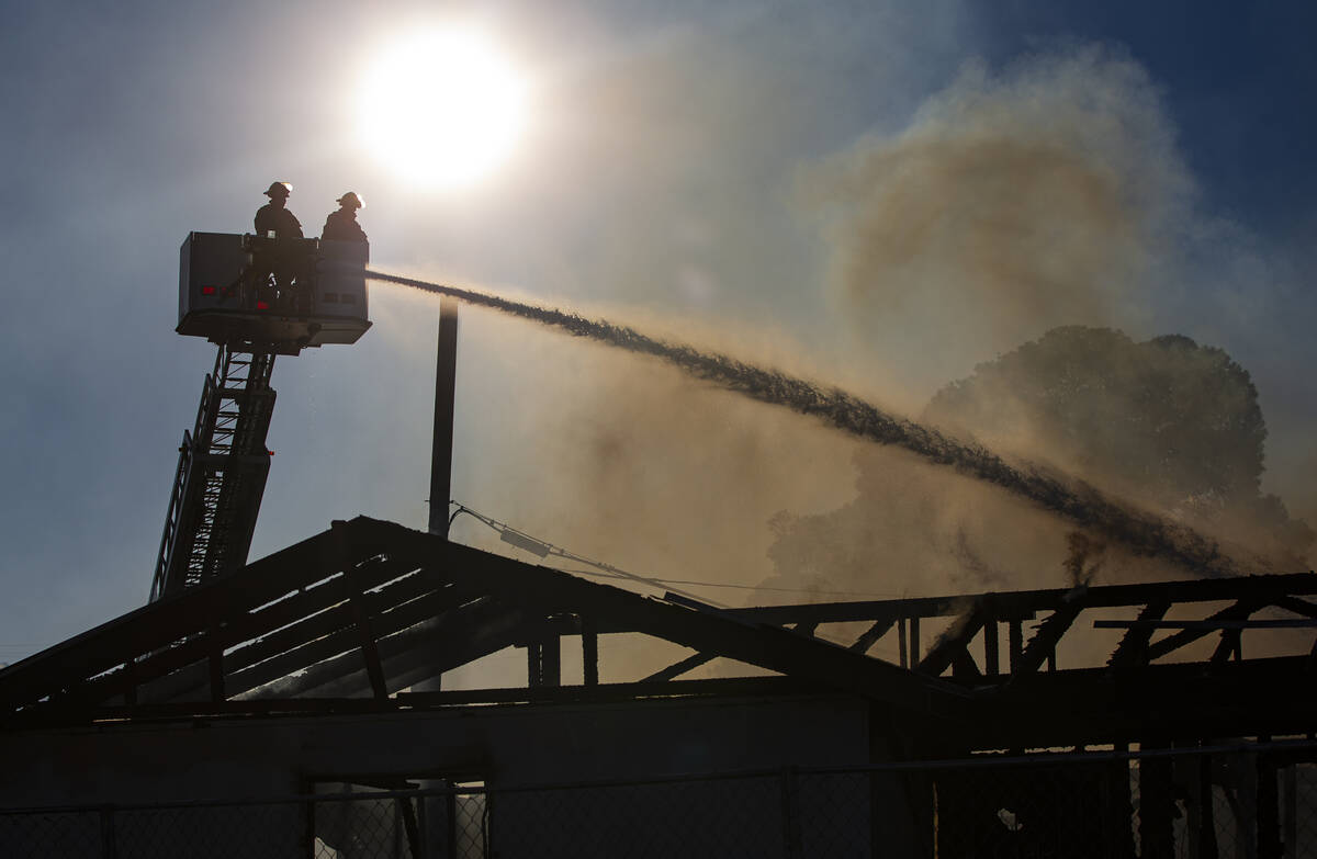 Las Vegas firefighters respond to the scene of a vacant building on fire at Maryland Parkway an ...