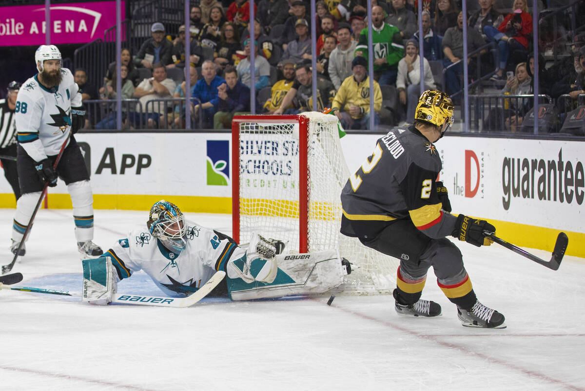 Golden Knights defenseman Zach Whitecloud (2) shoots on San Jose Sharks goaltender James Reimer ...