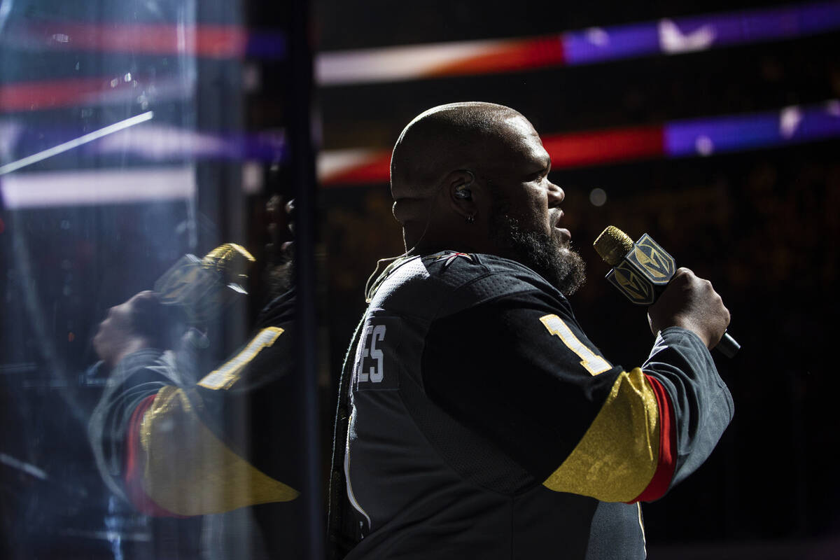 Carnell Johnson performs the national anthem before the start of an NHL hockey game between the ...