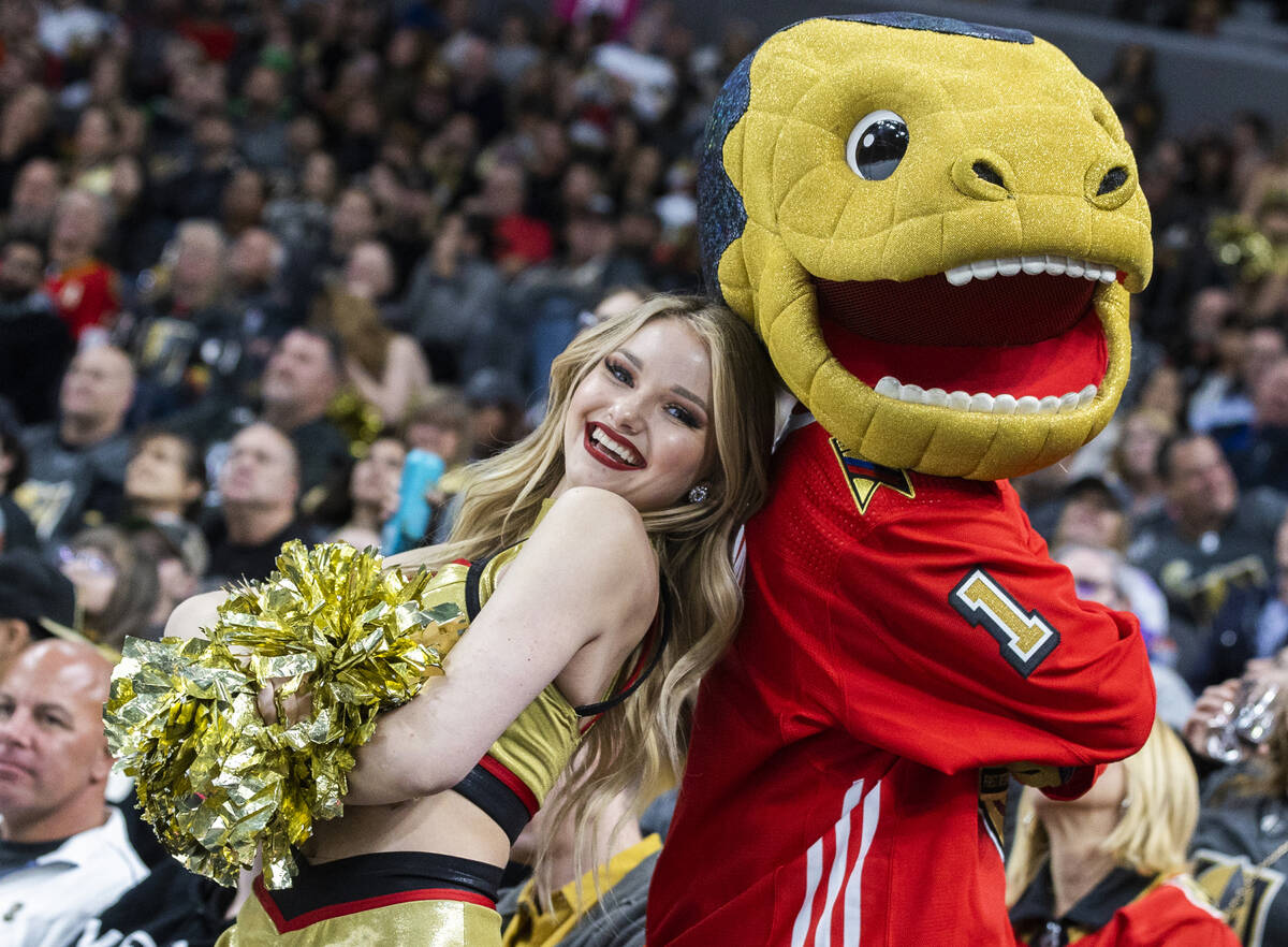 A Golden Knights cheerleader with mascot “Chance” in the third period during an N ...