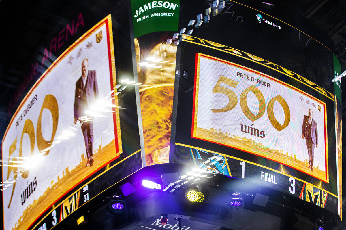 Golden Knights head coach Peter DeBoer is honored for his 500th win at the end of an NHL hockey ...