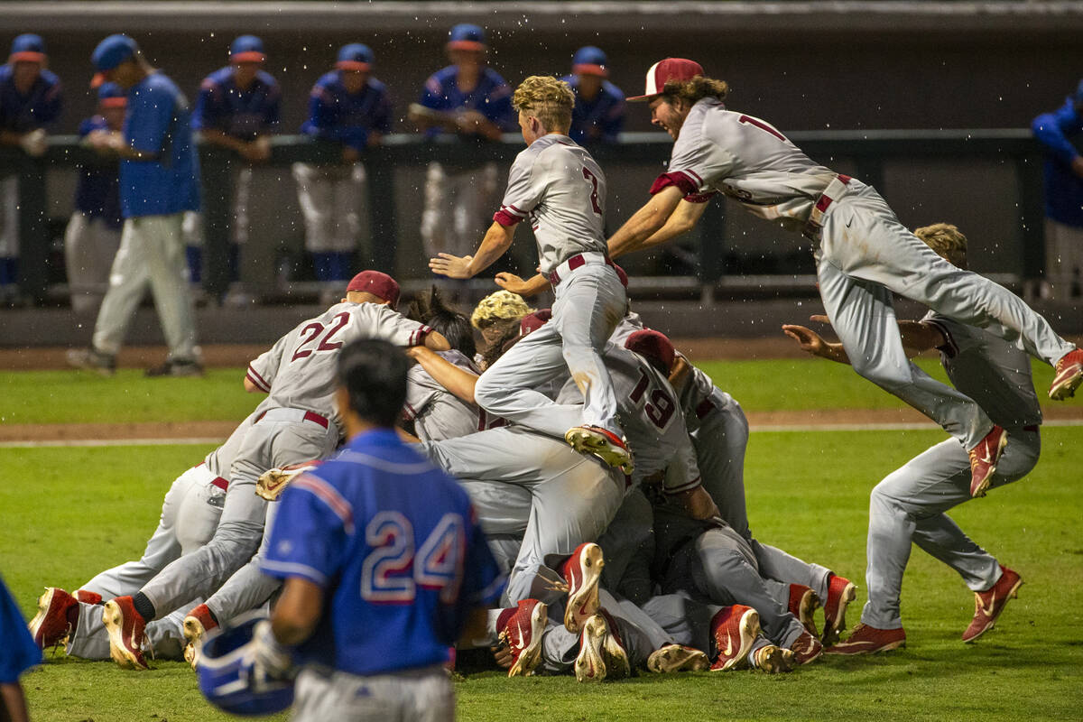 Desert Oasis players celebrate their win over Reno 9-1 during the tie-breaker game of their Cla ...